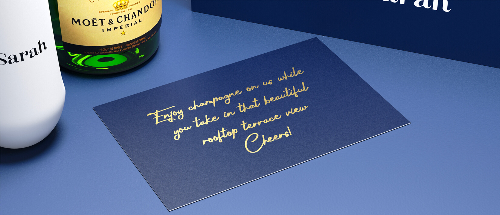 Celebratory champagne flutes and bottle in a personalized gift box.